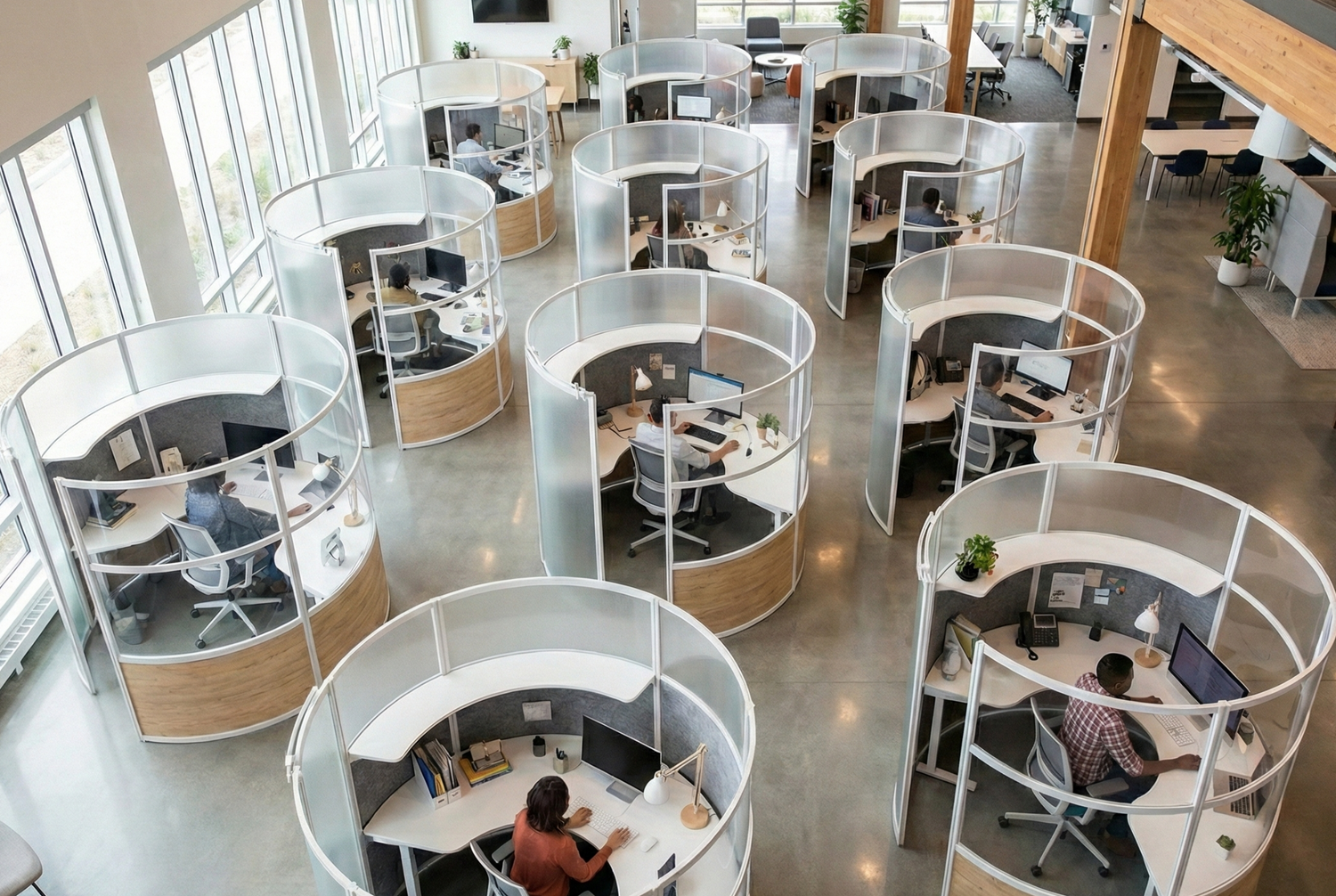 Modern office layout with circular workstations and large windows.